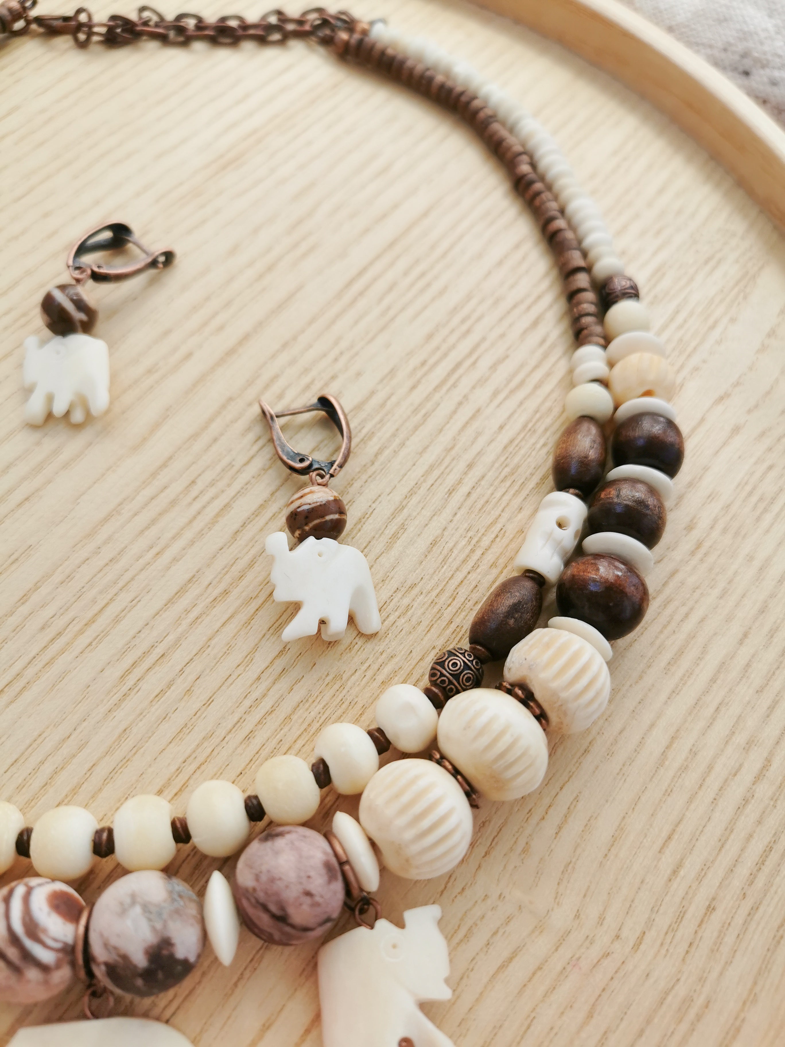 Bone bead jewelry set with elephant charms.