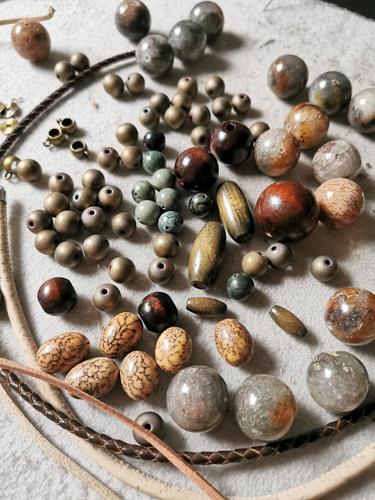 various shapes and colours natural material beads laying on a table