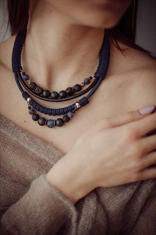 black and blue cord necklace with beads worn by women