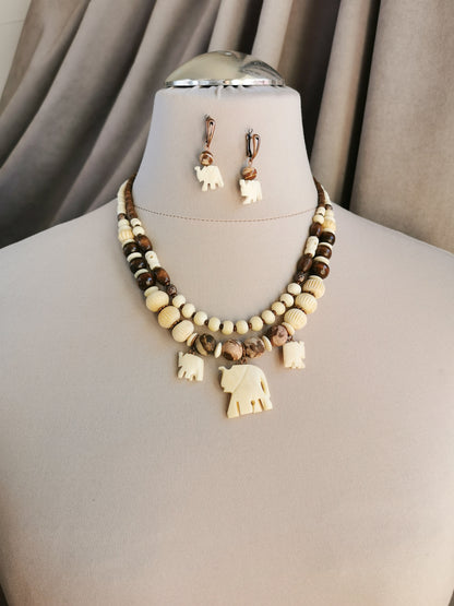 Bone bead jewelry set with elephant charms.