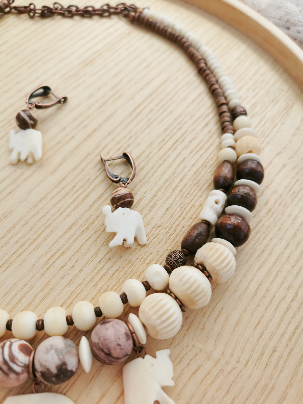 Bone bead jewelry set with elephant charms.