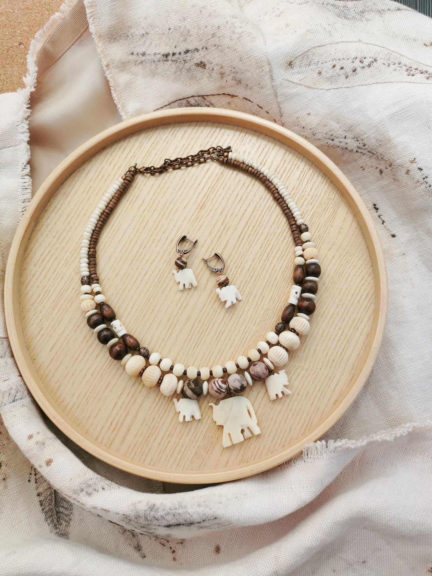 Bone bead jewelry set with elephant charms.