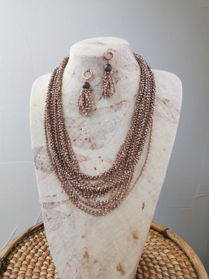 beige bead string necklace and earrings on a display 