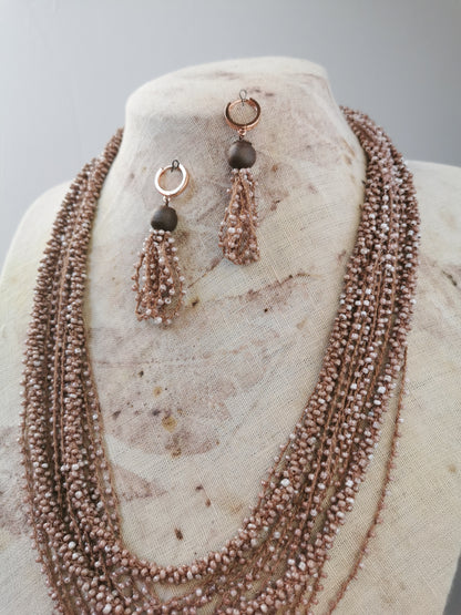 beige bead string necklace and earrings on display