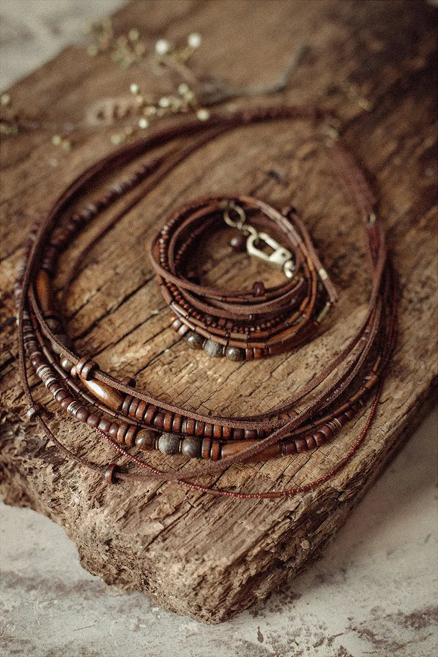 Multilayer bead string jewelry set Vika Studio on rustic surface