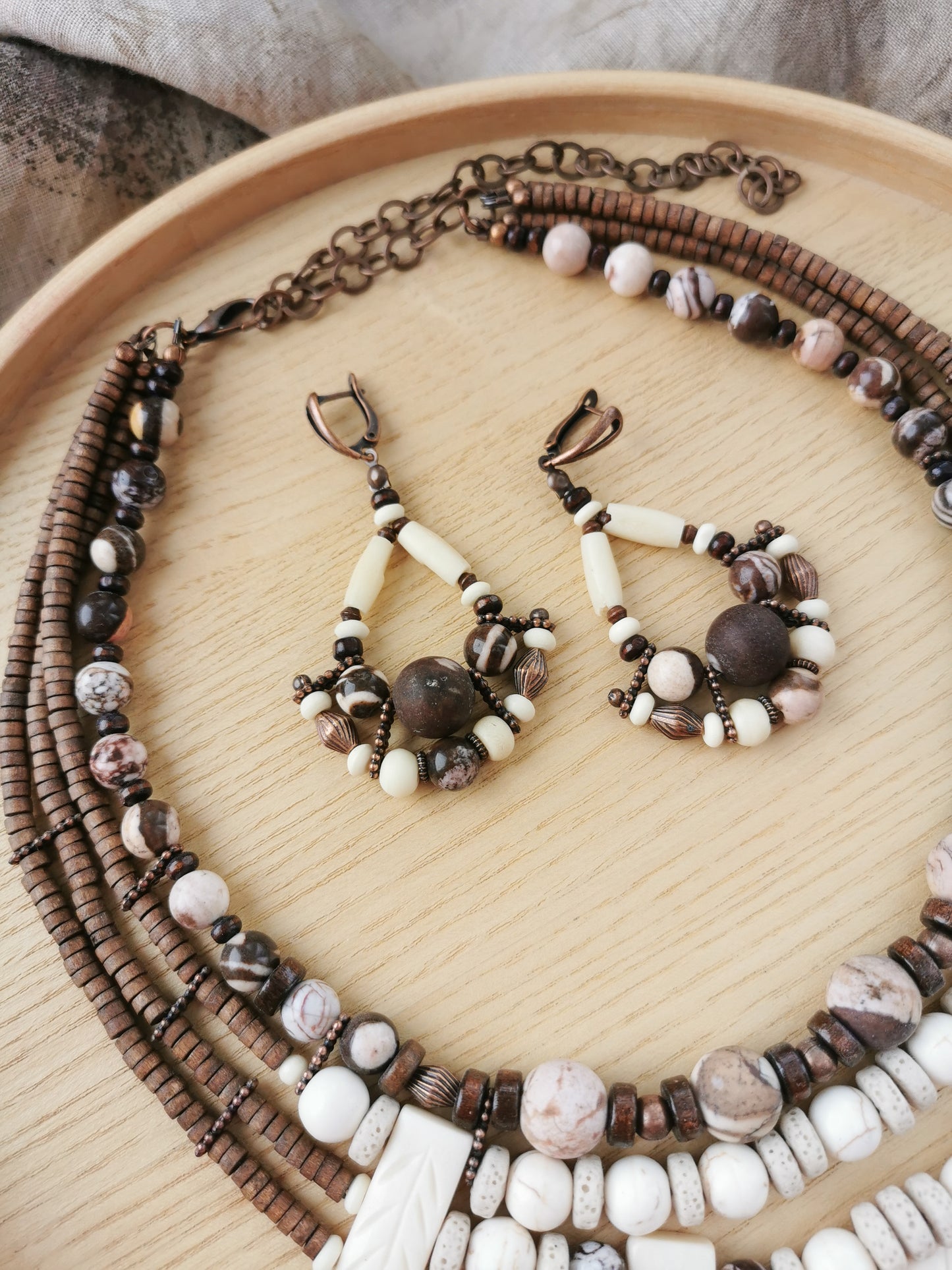 Beaded boho necklace and earrings on a wooden surface