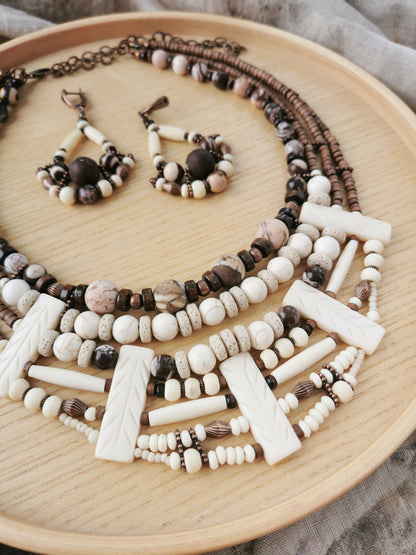 multilayer boho Beaded necklace and earrings on a wooden surface