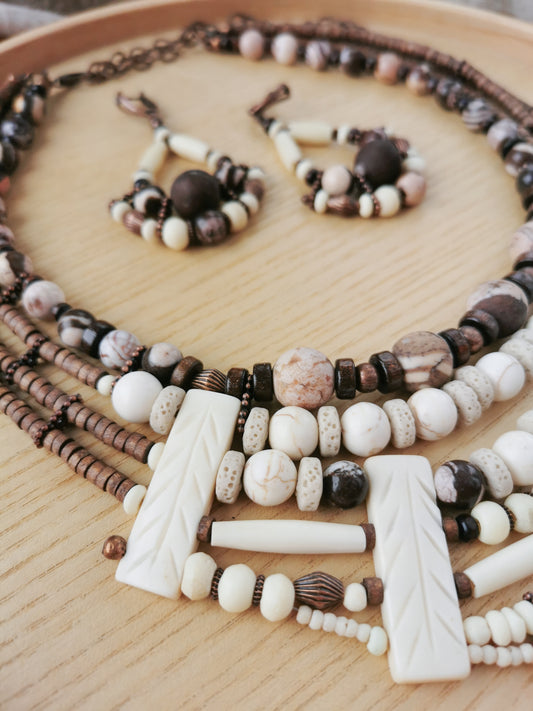 multilayer boho Beaded necklaces and earrings on a wooden surface