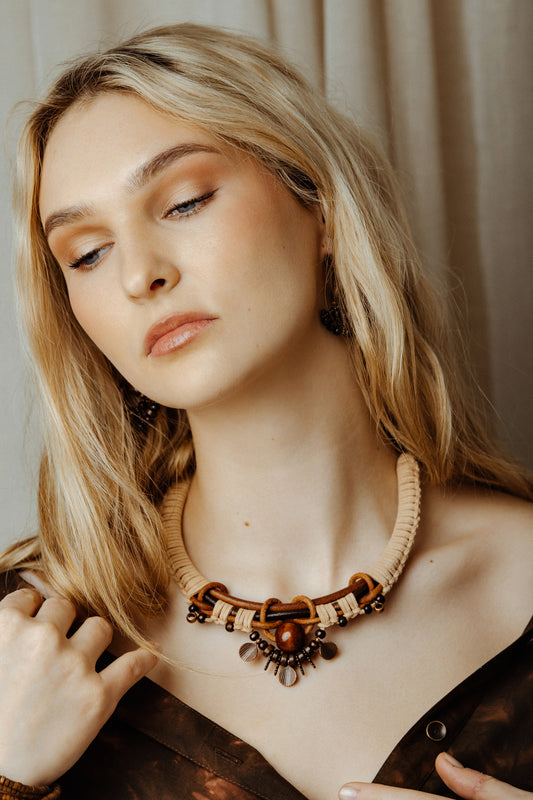 Woman wearing a necklace with a neutral background