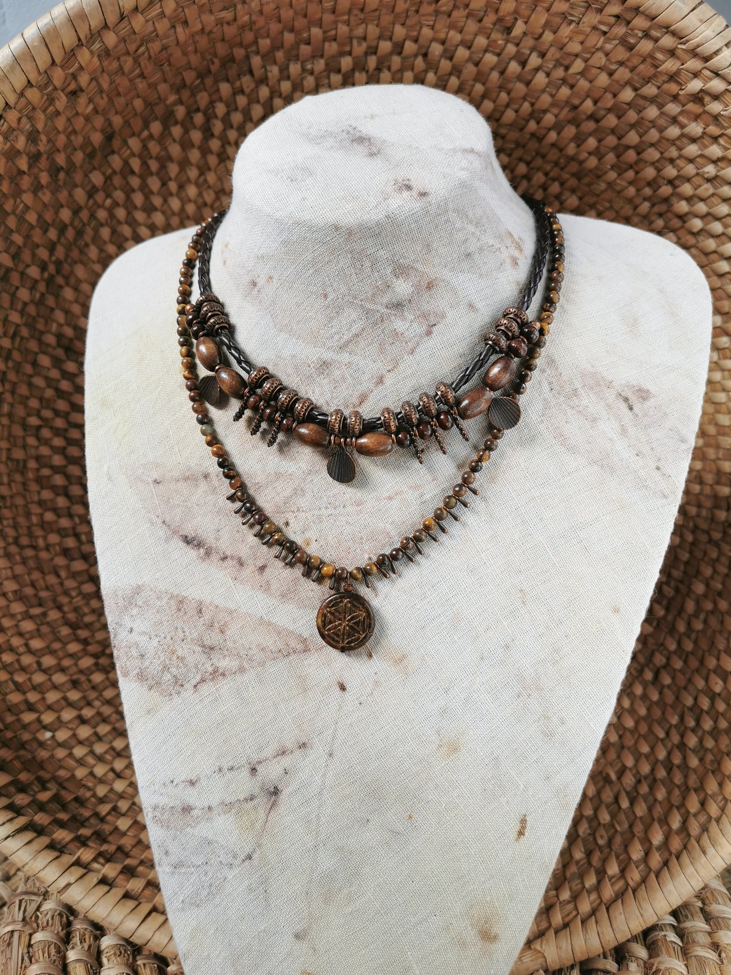 boho rustic jewlery set on a mannequin bust against a woven background