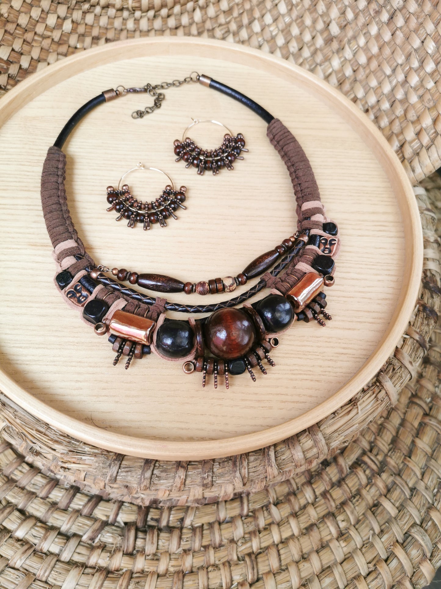 Necklace and earrings set on a woven surface