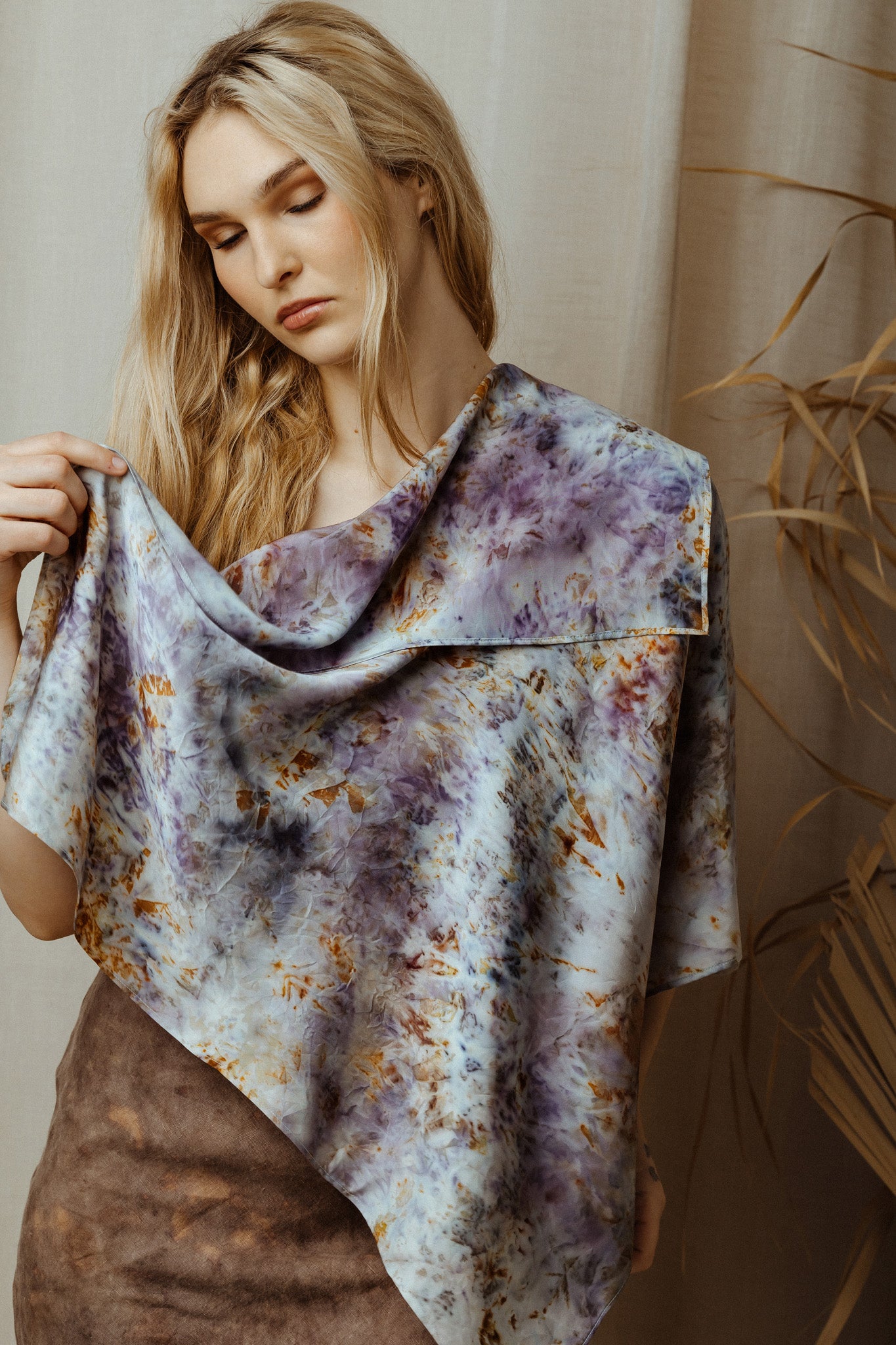 women with draped botanical dye silk scarf over her shoulder