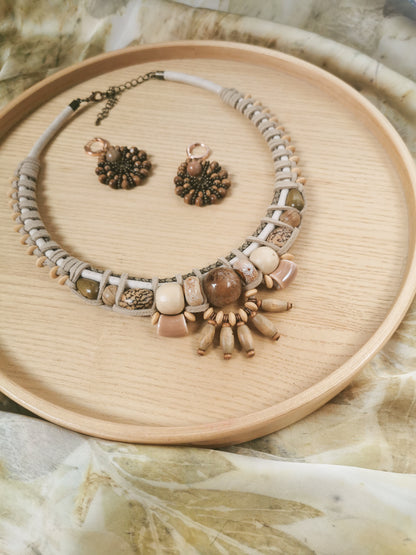 Necklace and earrings set on a wooden tray