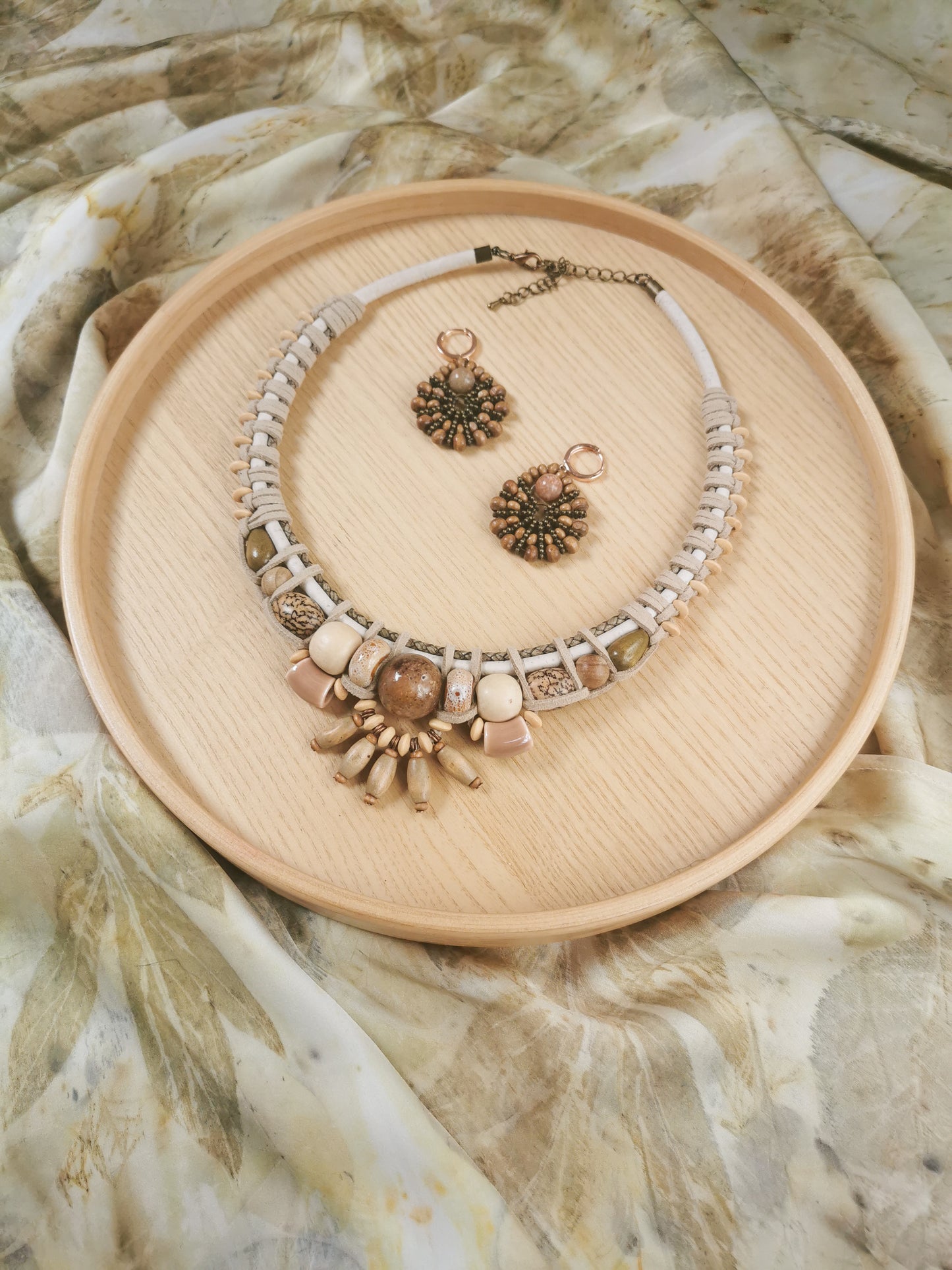 earthy boho Jewelry set with necklace and earrings on a beige plate