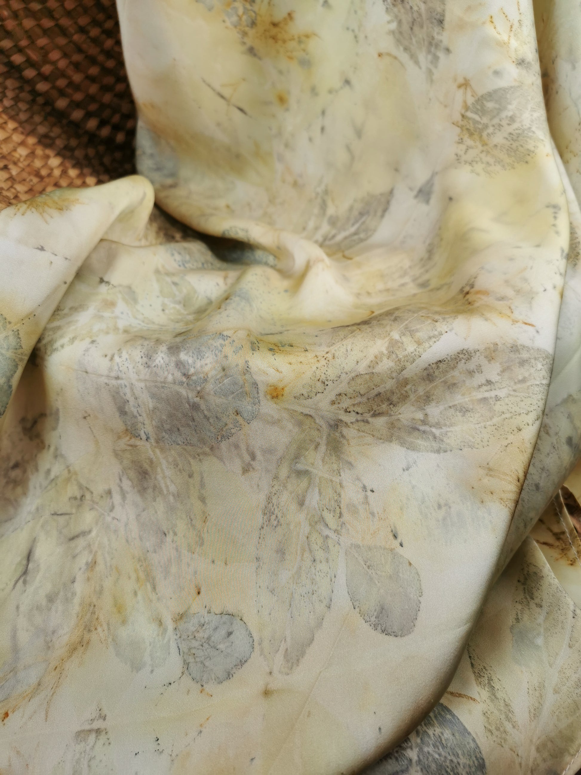 Close-up of a eco-printed silk scarf with a neutral color palette.