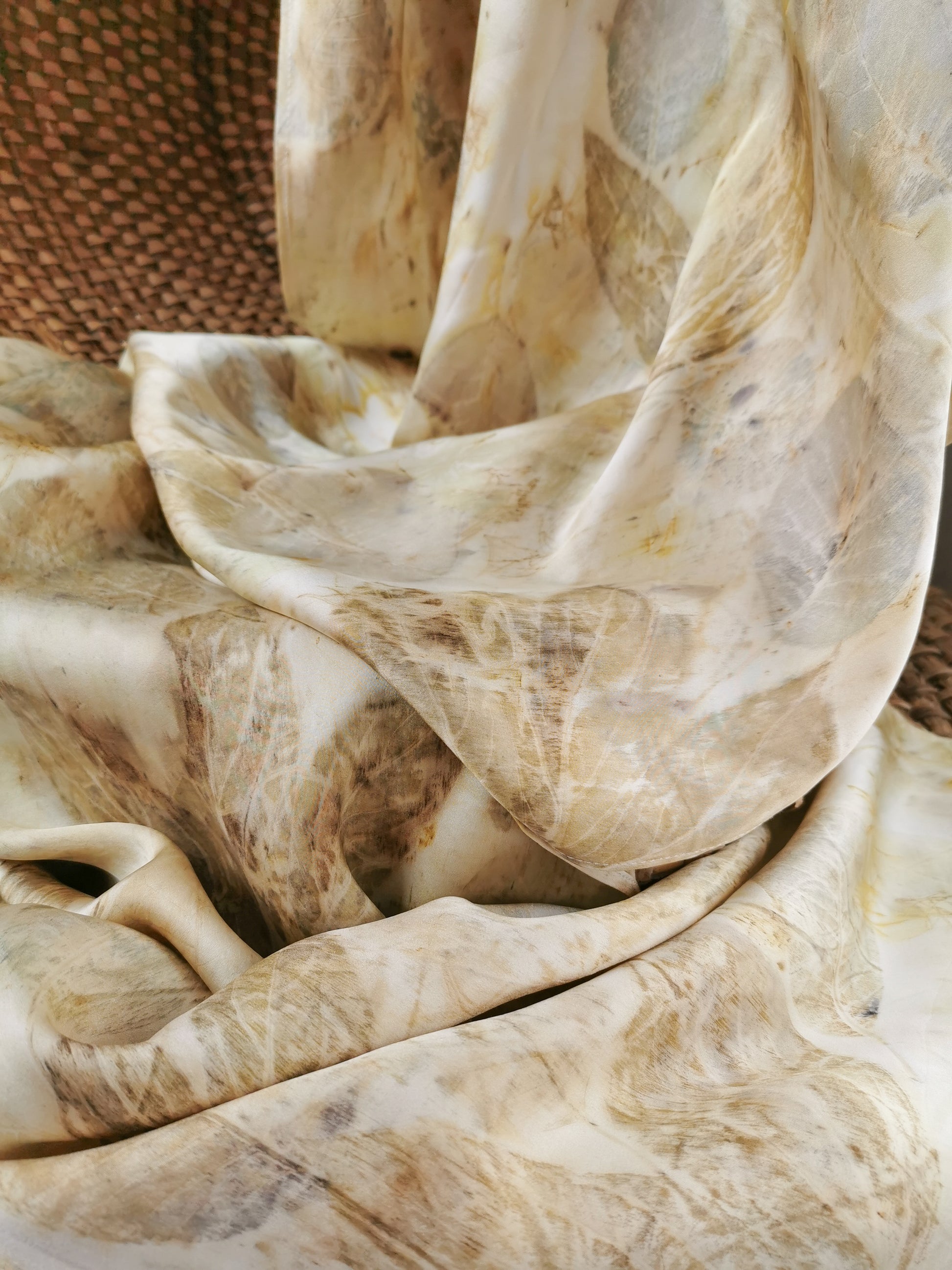 Close-up of beige eco-printed silk scarf with floral prints