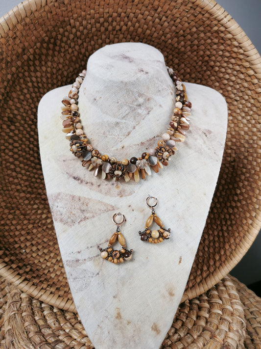 statement bead and charm necklace with earrings on a display
