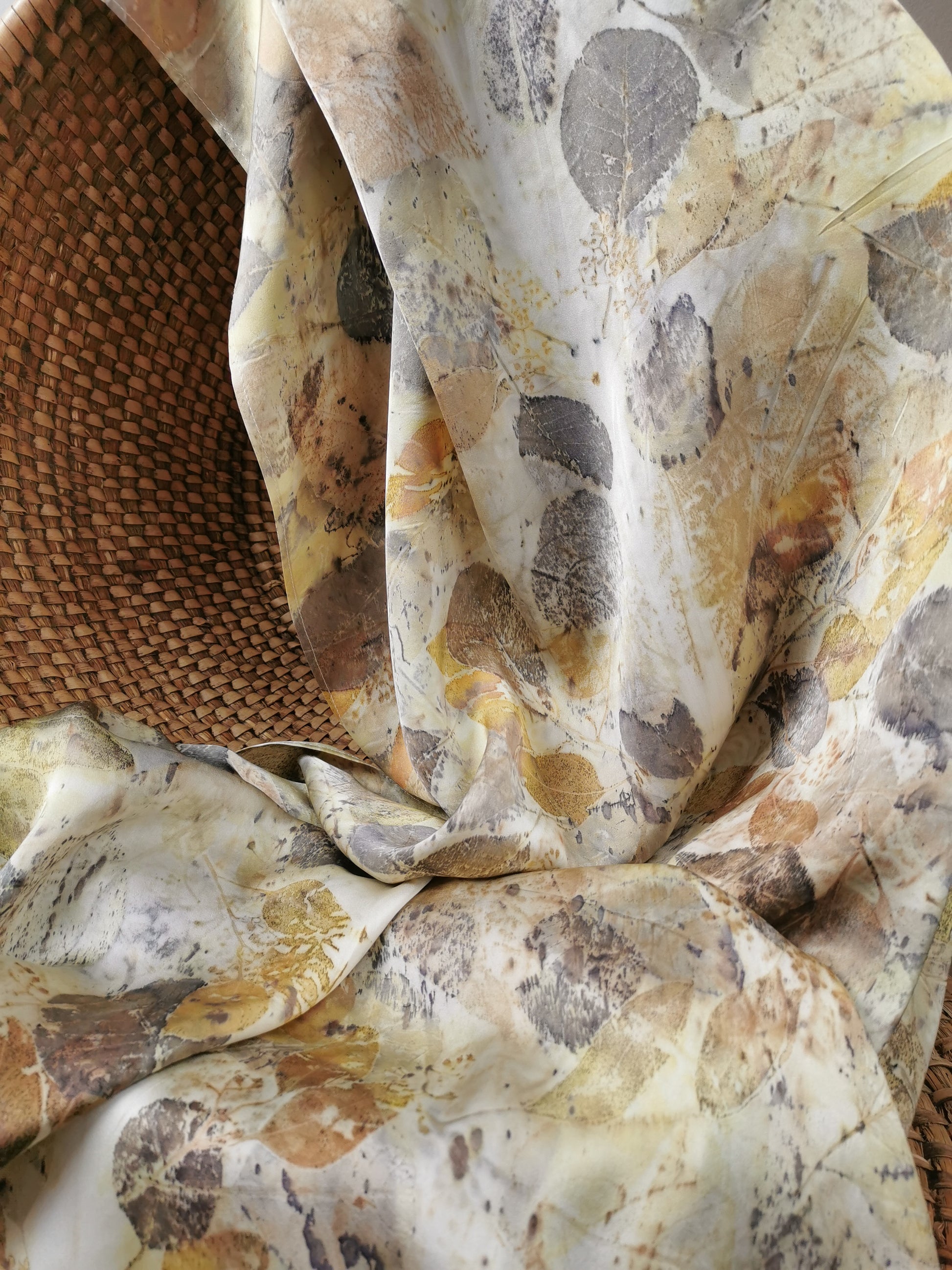 Close-up of leaf eco-printed silk scarf with a textured surface