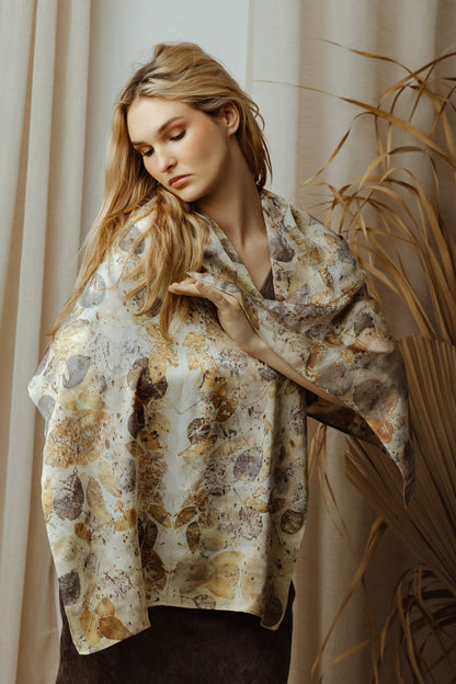 Woman wearing a patterned shawl in a warm-toned indoor setting
