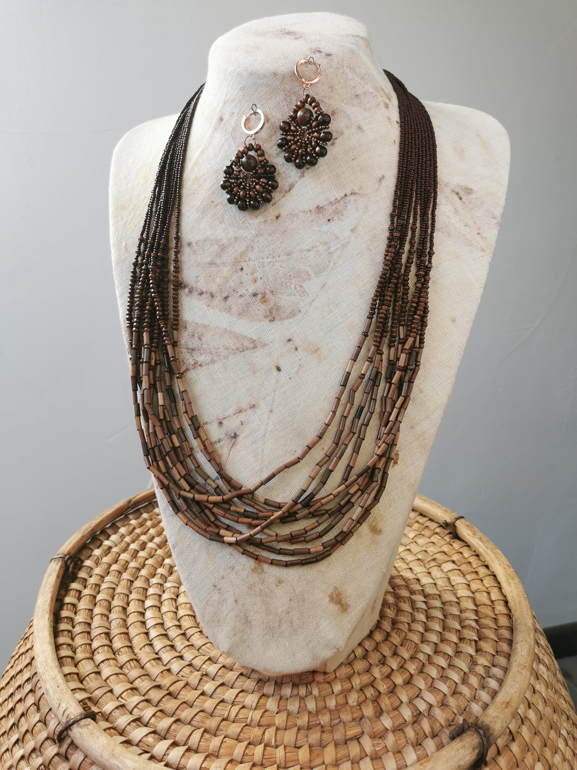 long boho bead layering necklace and earrings set on a display