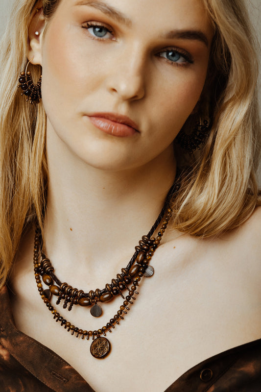 model wearing rustic bead necklace set with a neutral background