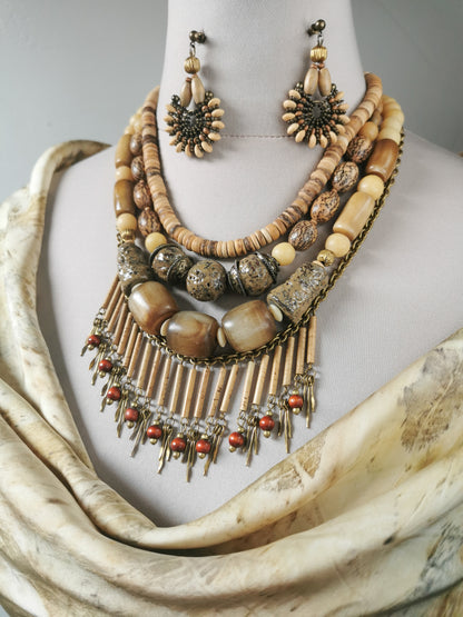Necklace and earrings set on a mannequin with a neutral background