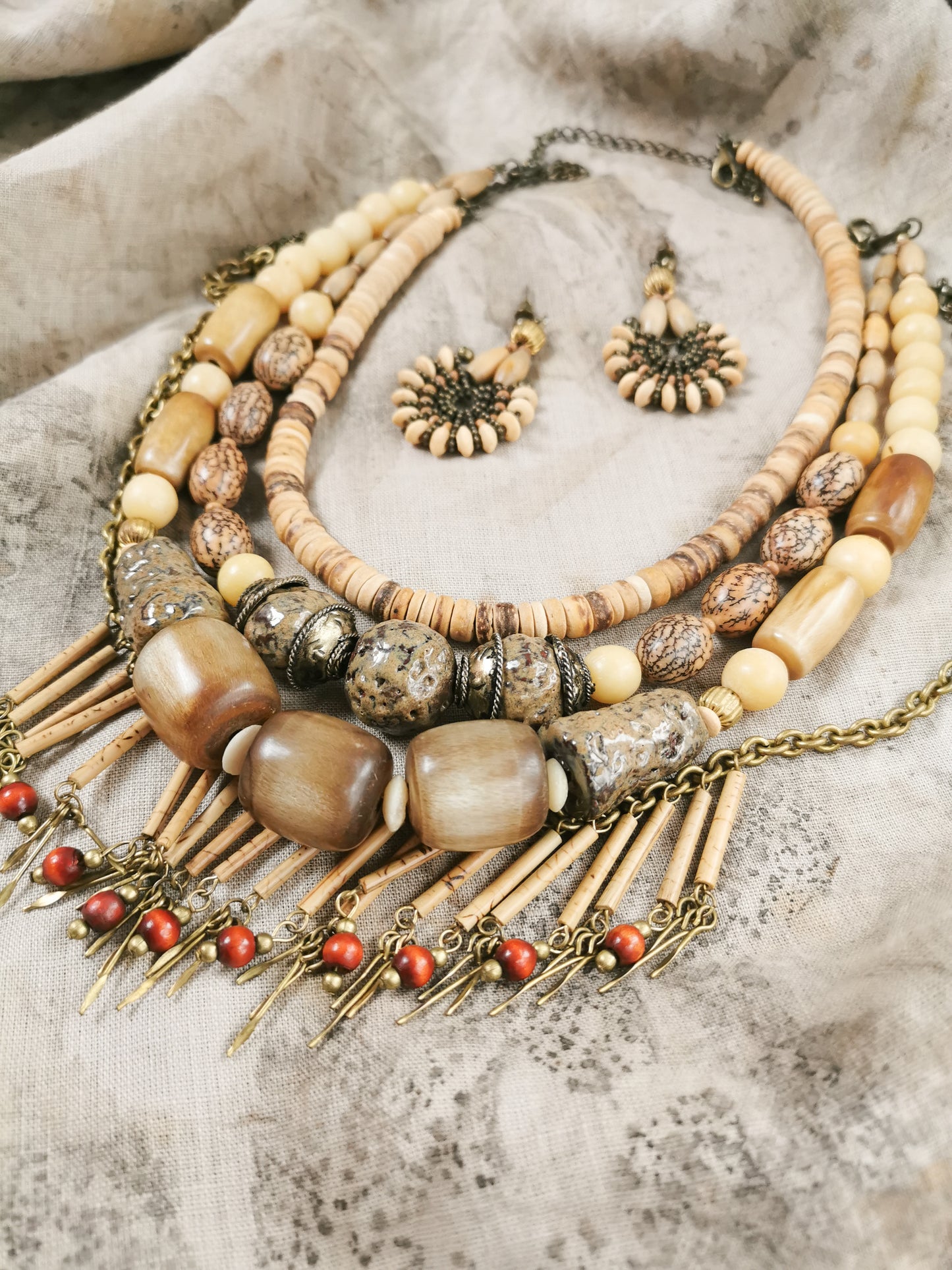 Necklace with beads and chain on a textured surface