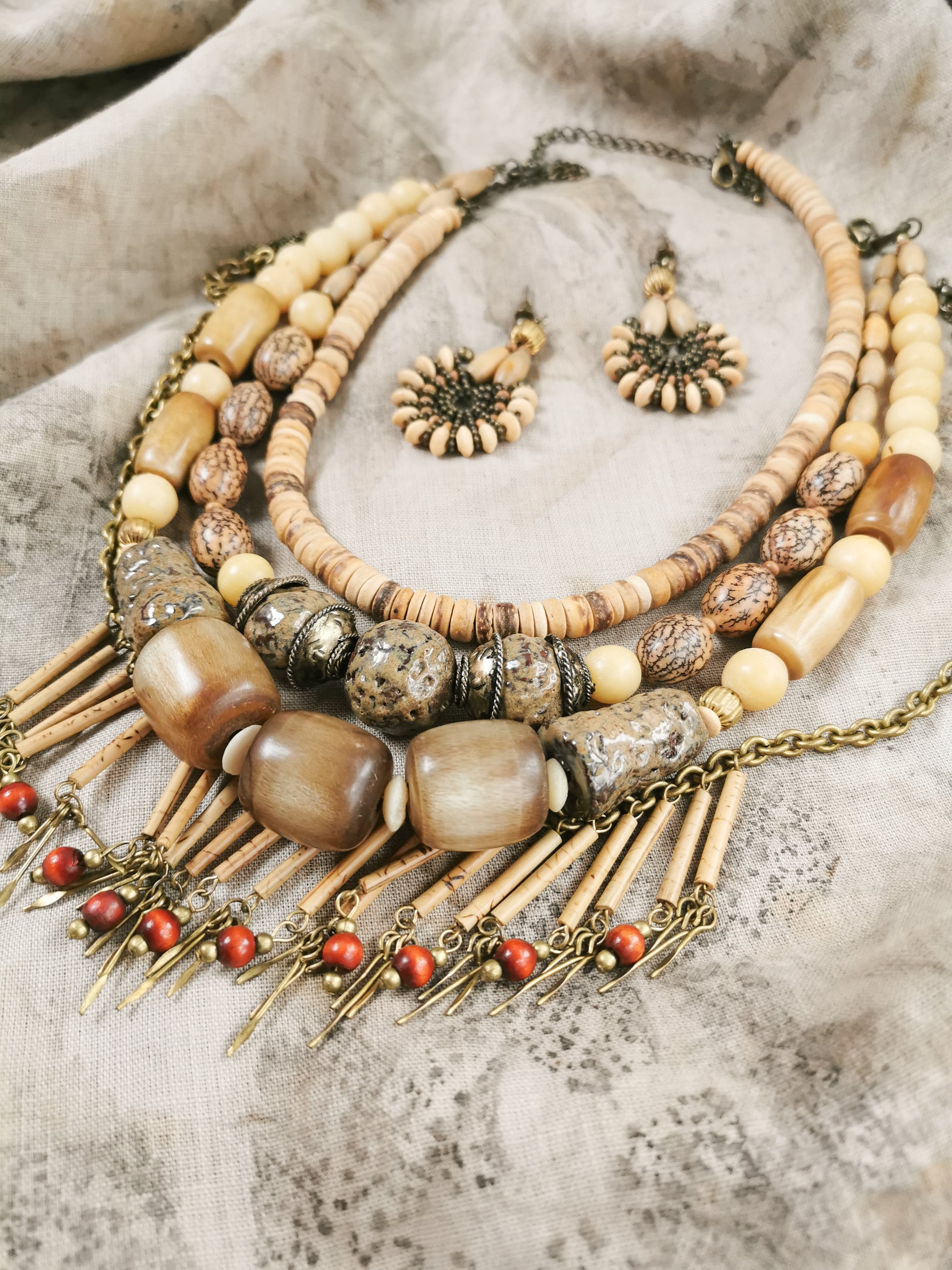 Necklace with beads and chain on a textured surface