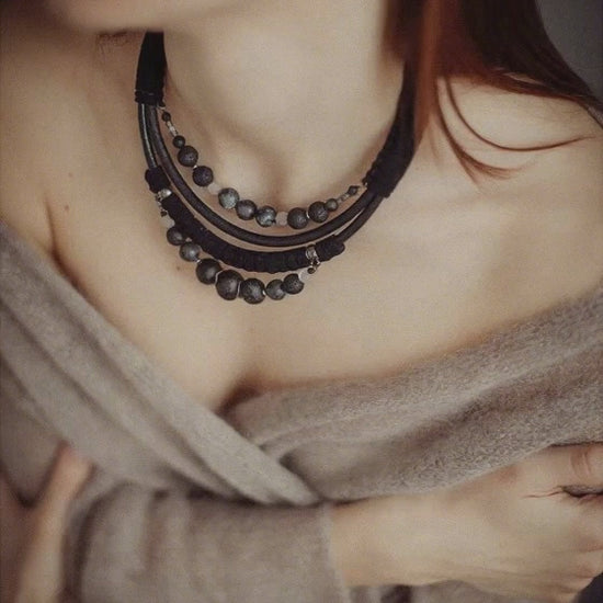 women wearing black layering beads necklace moves from one side to other