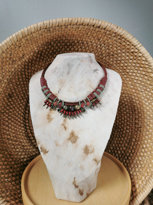 Necklace on a white stone bust with a woven basket background