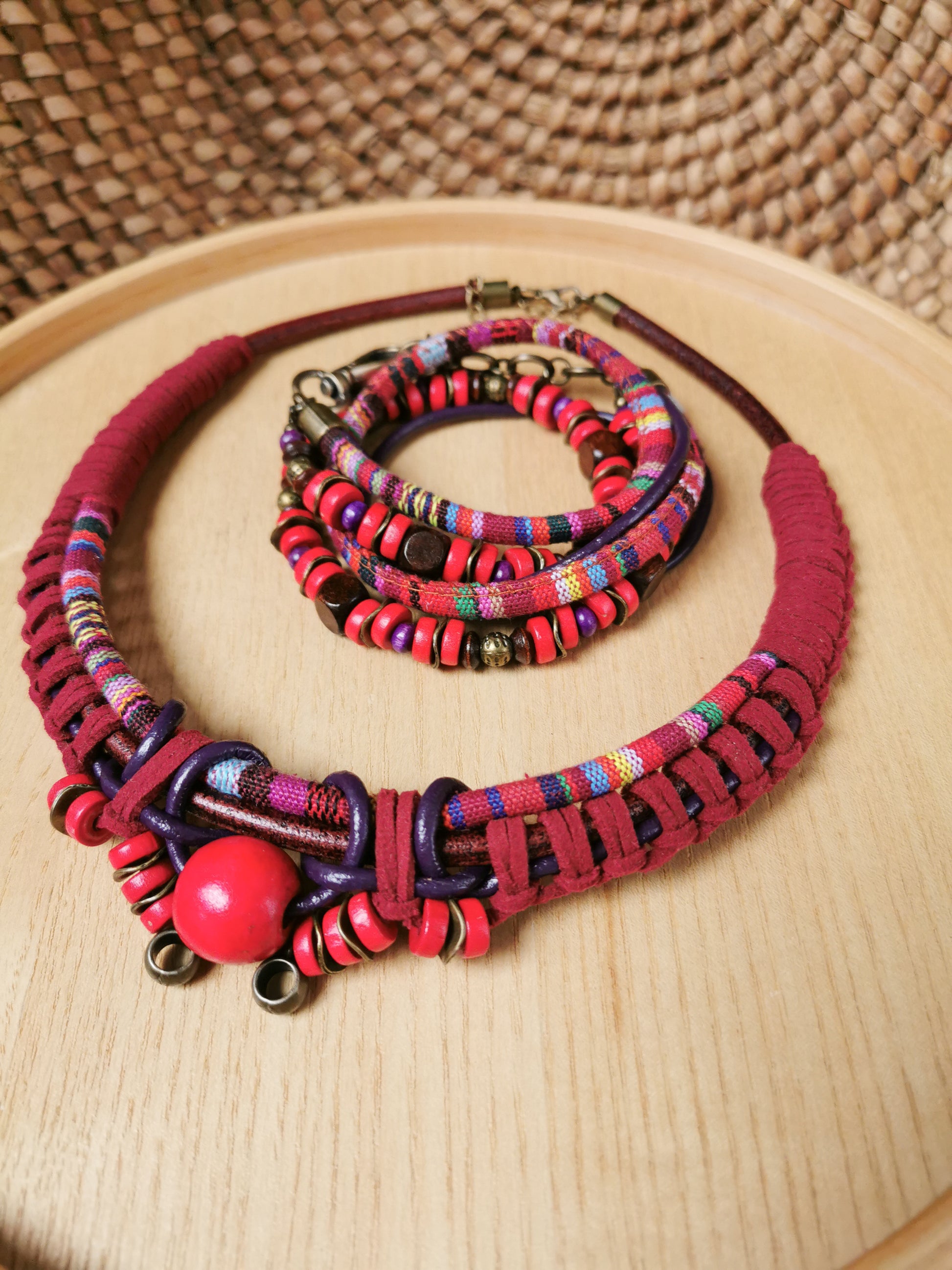Colorful necklace and bracelet set on a wooden surface