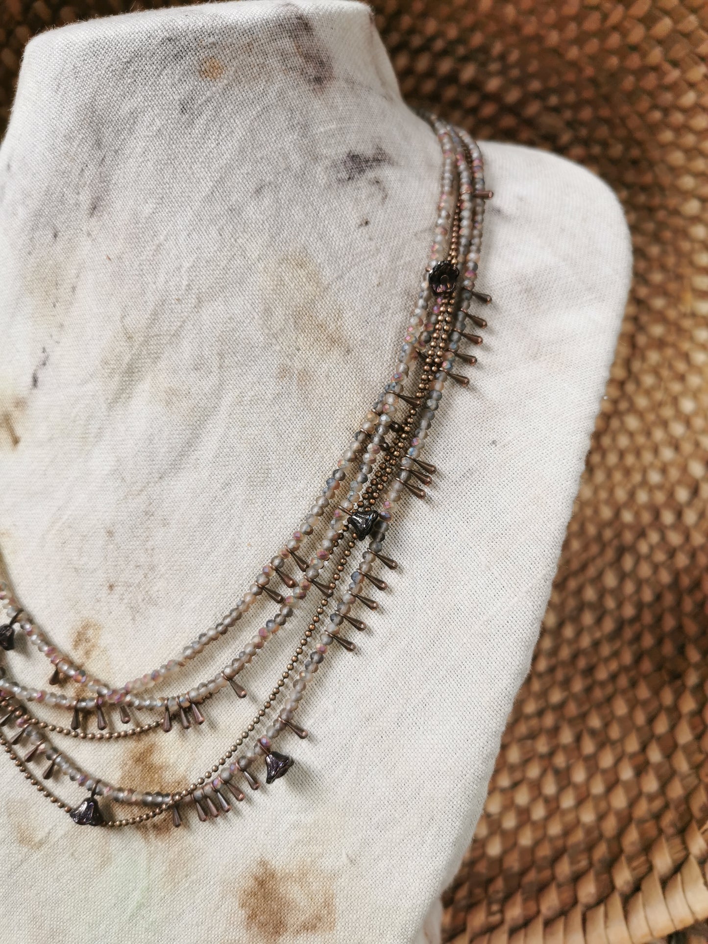 dainty seed bead necklace on a jewelry stove