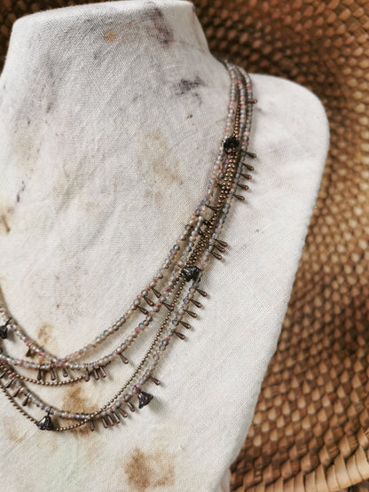 dainty seed bead necklace on a jewelry stove