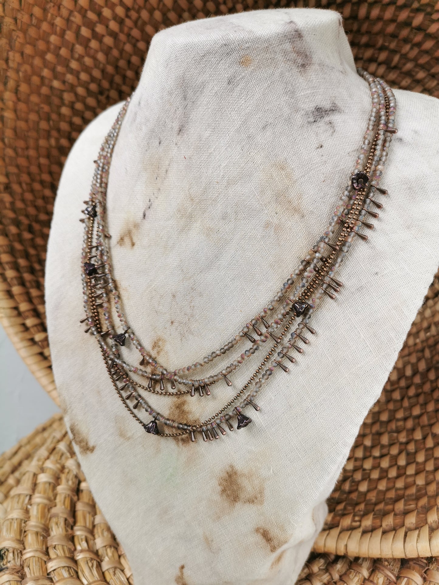 dainty seed bead multilayer necklace on a jewelry stove