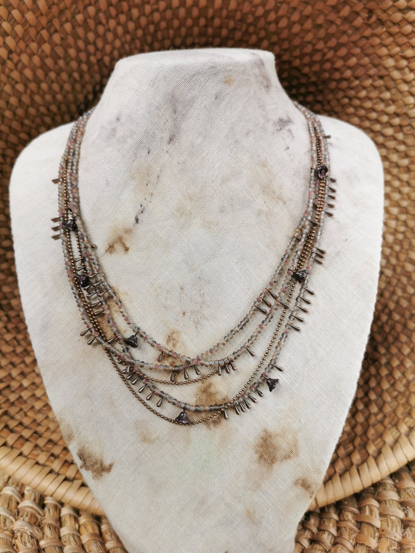 dainty seed bead multilayer necklace on a jewelry stove