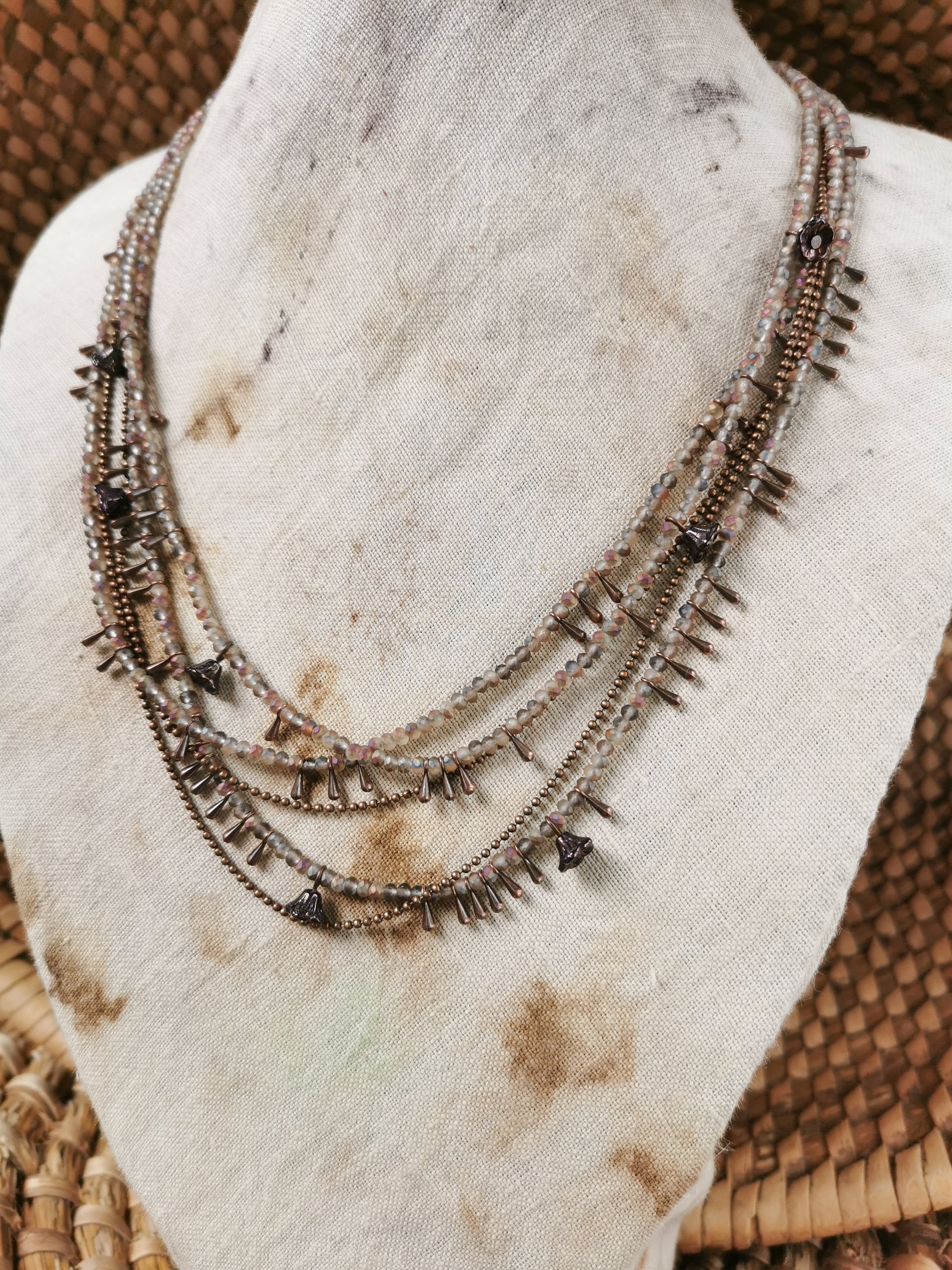 dainty seed bead multilayer necklace on a jewelry stove
