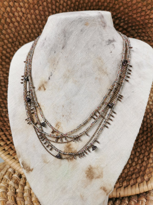 dainty seed bead multilayer necklace on a jewelry stove
