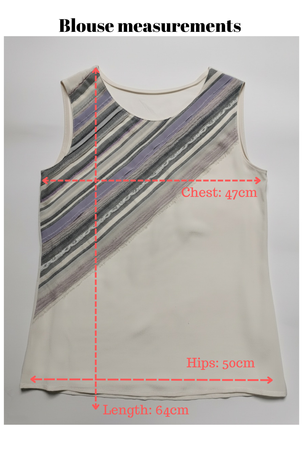 Beige sleeveless top with measurement markings on a gray background