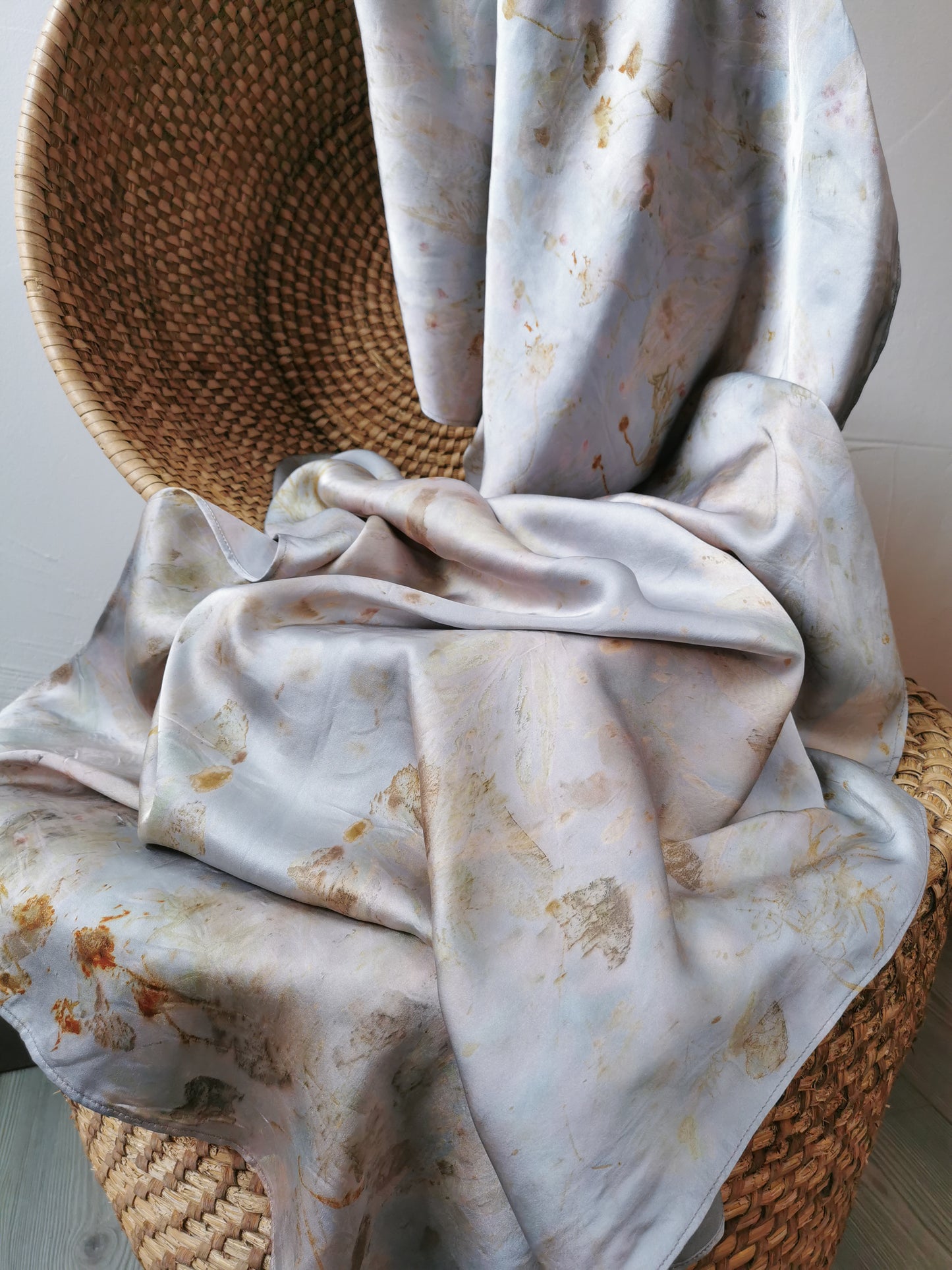 silver botanical dye silk shawl on a woven basket