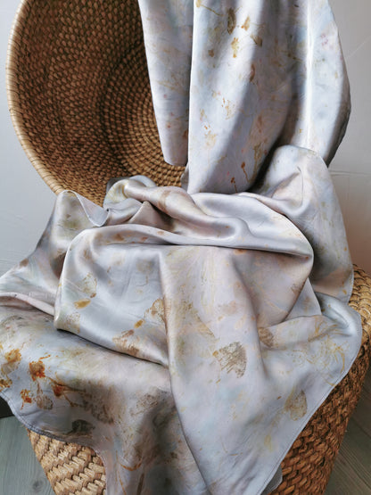 silver botanical dye silk shawl on a woven basket