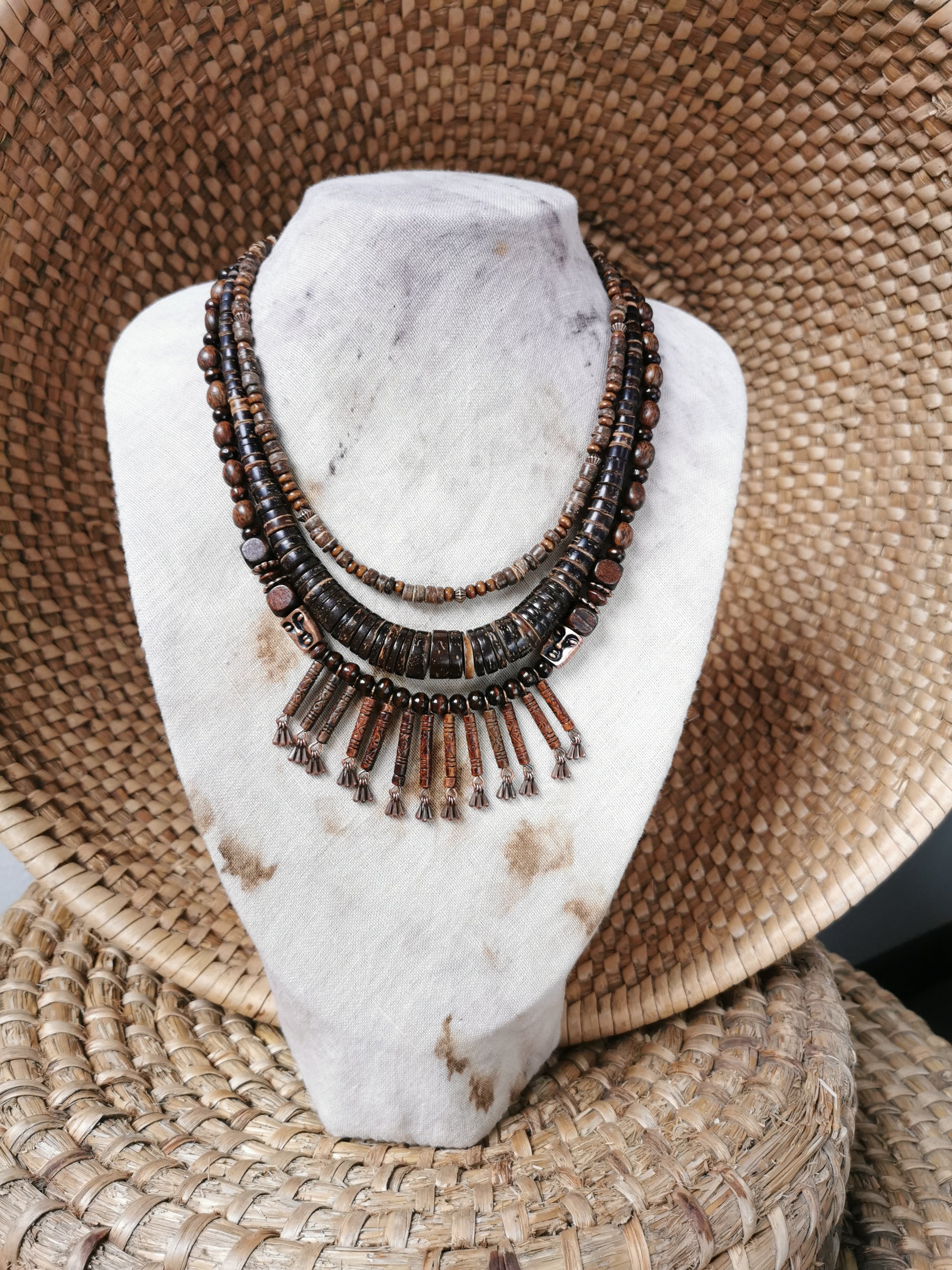 Necklace on a marble stand with a woven basket background
