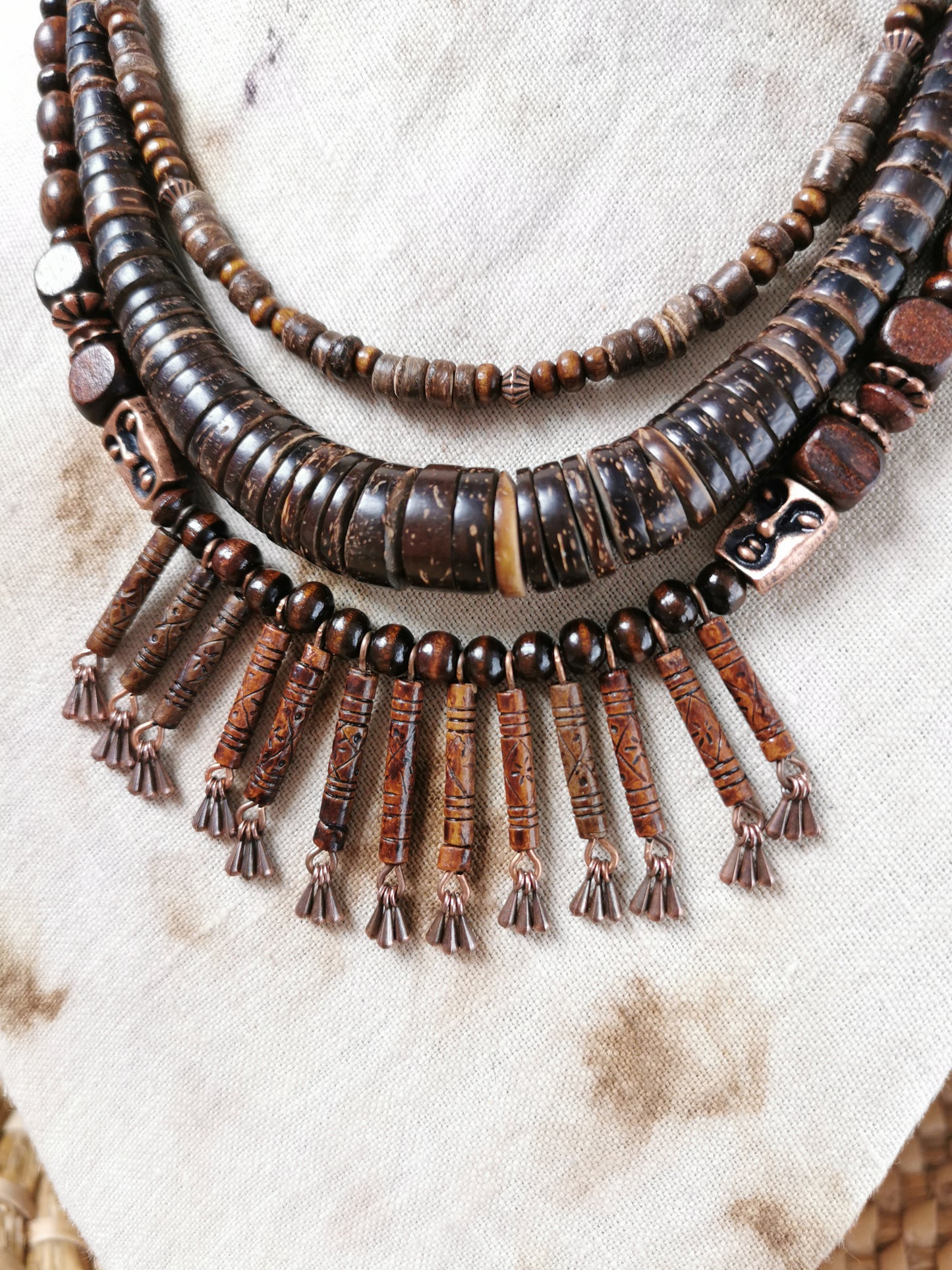Beaded necklace with tassels on a textured surface
